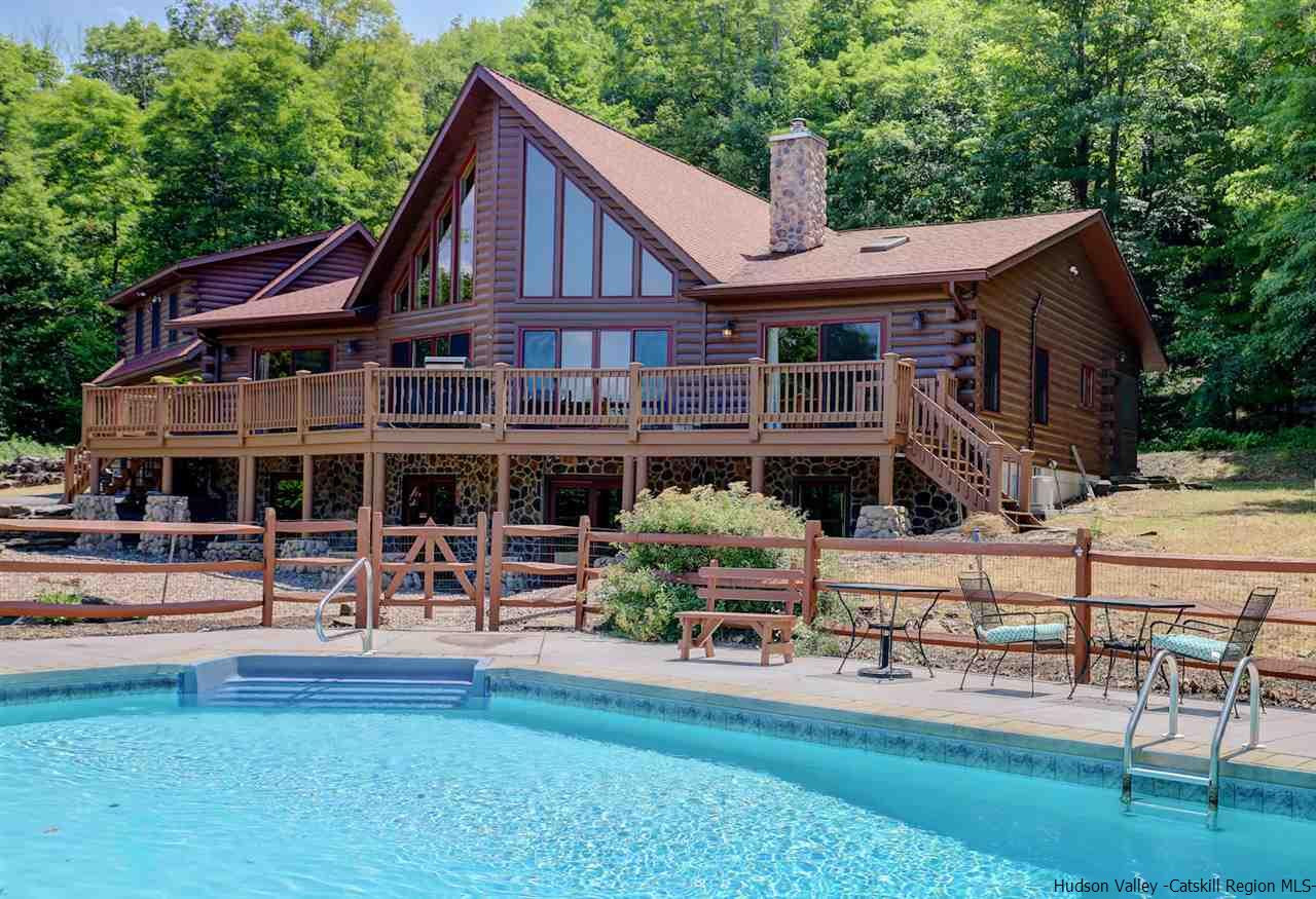 401 Cold Brook Road Bearsville, NY 12409 - Photo 1 of 35 a front view of a house with garden and sitting area