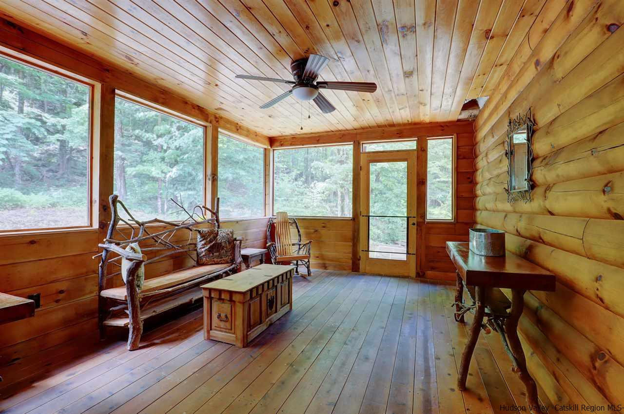 401 Cold Brook Road Bearsville, NY 12409 - Photo 15 of 35 a living room with furniture a wooden floor and a large window