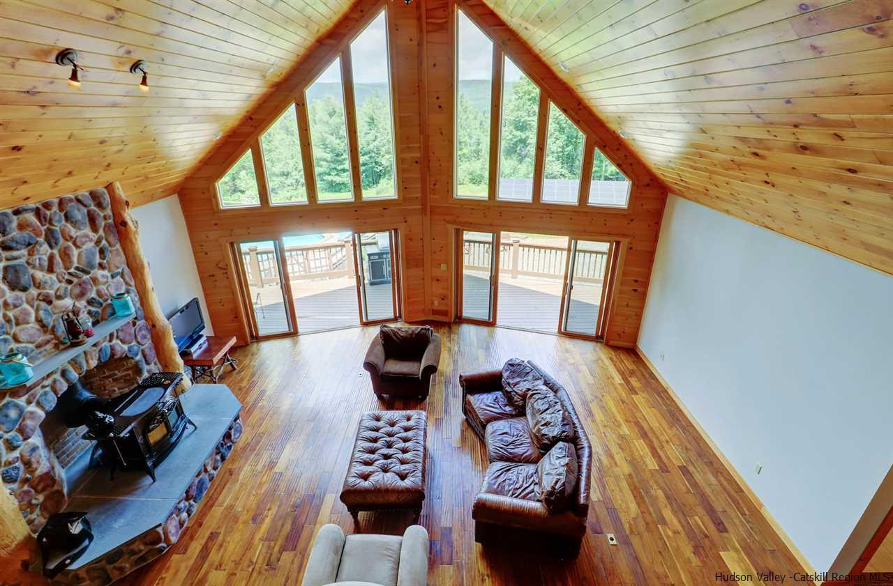 401 Cold Brook Road Bearsville, NY 12409 - Photo 17 of 35 a living room with furniture and a floor to ceiling window