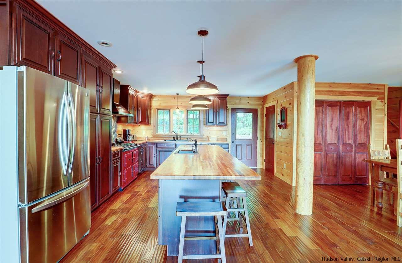 401 Cold Brook Road Bearsville, NY 12409 - Photo 4 of 35 a kitchen with stainless steel appliances granite countertop a refrigerator a stove and a wooden floors