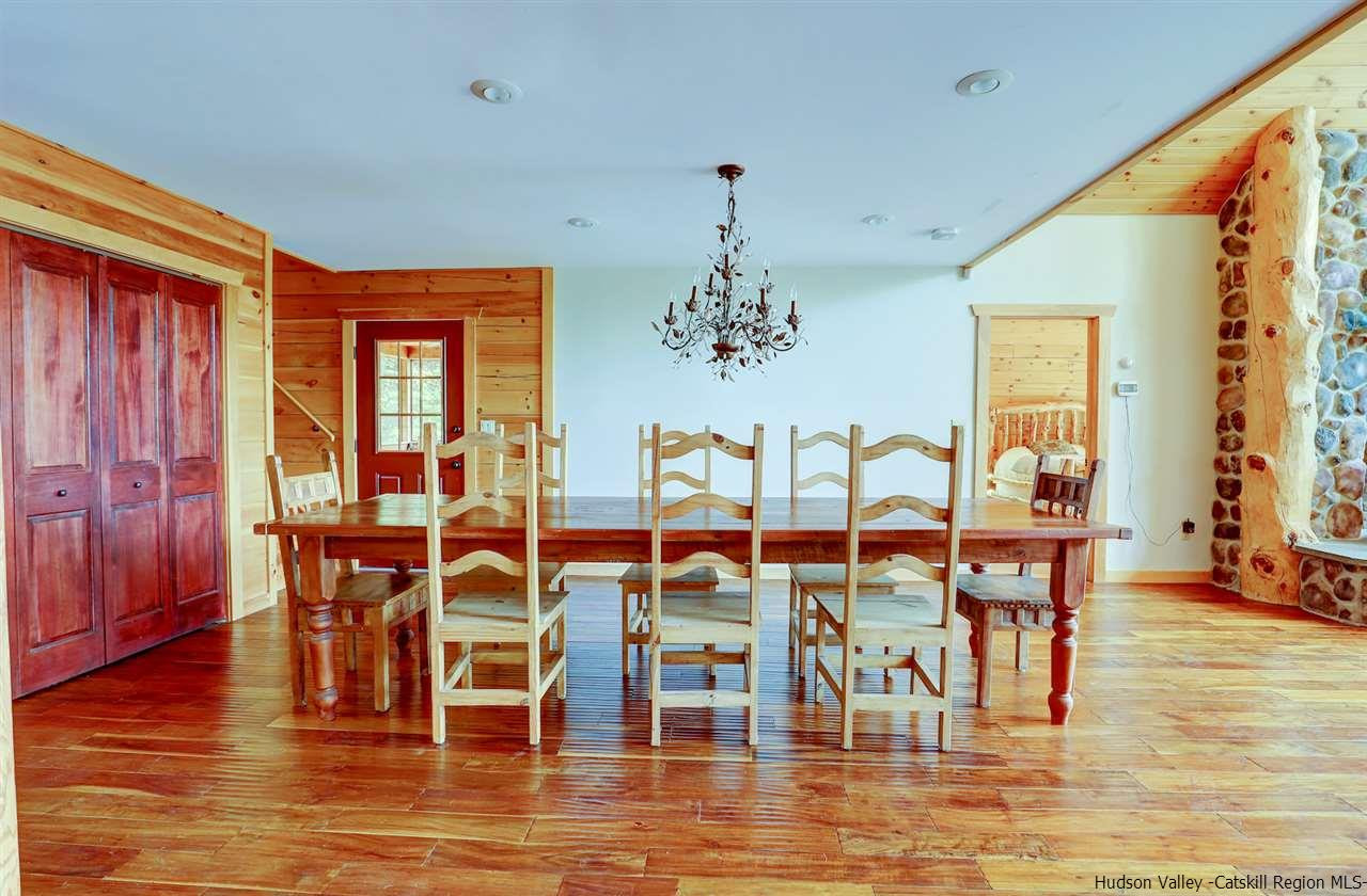 401 Cold Brook Road Bearsville, NY 12409 - Photo 8 of 35 a view of a dining room with furniture a chandelier and wooden floor