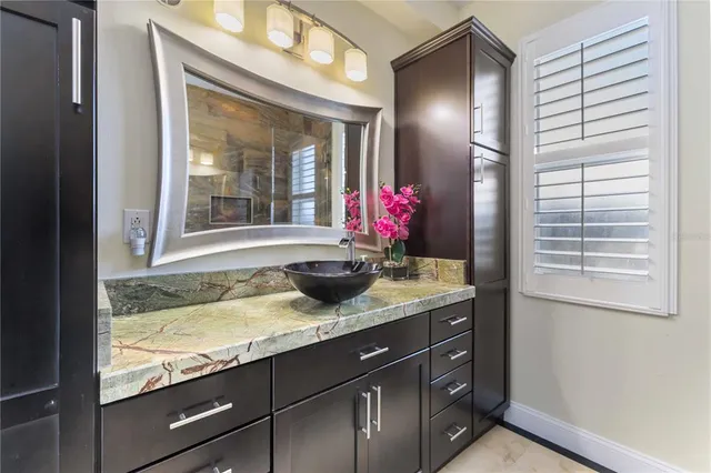 a bathroom with a double vanity sink toilet and shower
