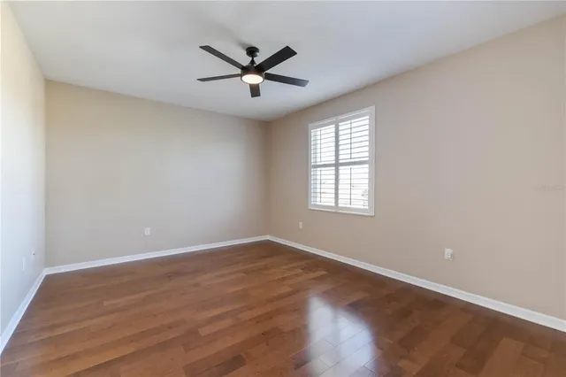 a view of a room with wooden floor windows and a chandelier