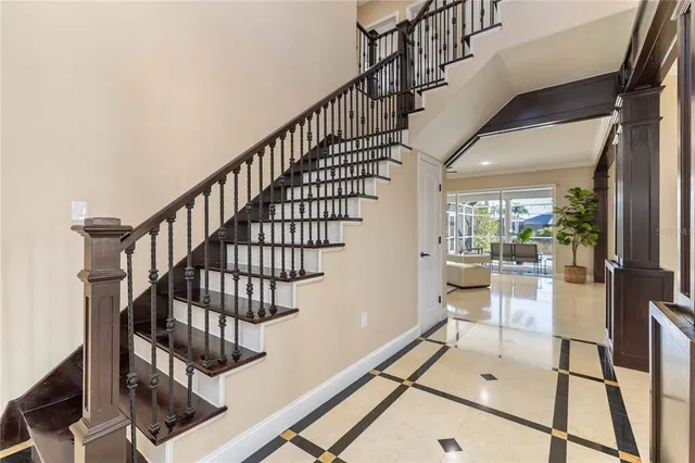 a living room with furniture and a glass door