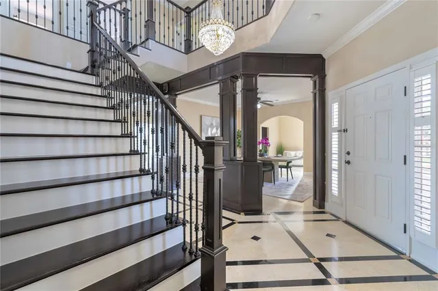 a view of an empty room with furniture and windows