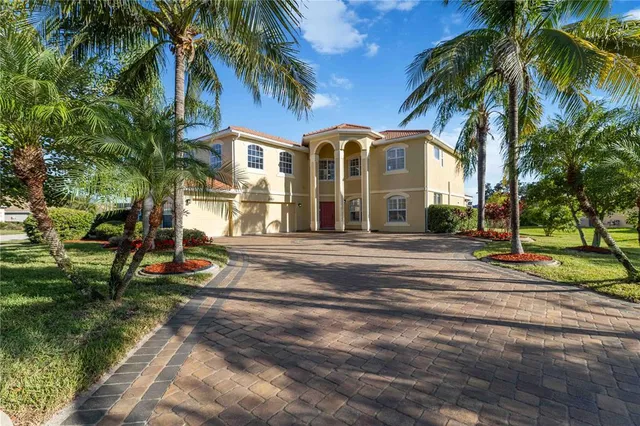 an aerial view of a house with a garden and lake view
