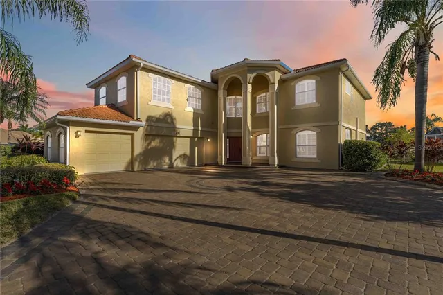 an aerial view of a house with outdoor space and lake view
