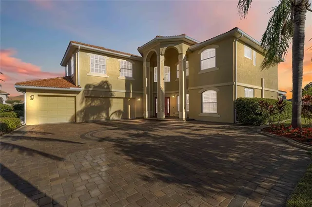 an aerial view of a house with outdoor space and lake view