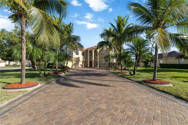 an aerial view of residential houses with outdoor space and lake view