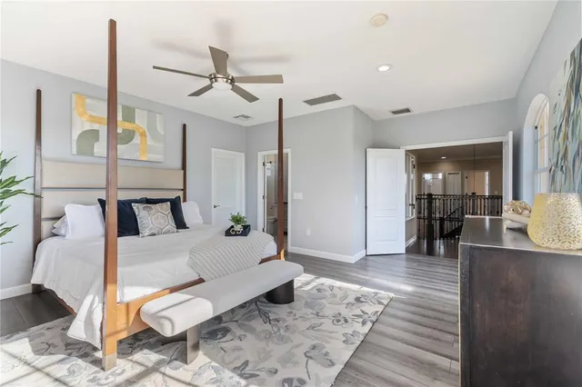 a bedroom with a bed and a potted plant