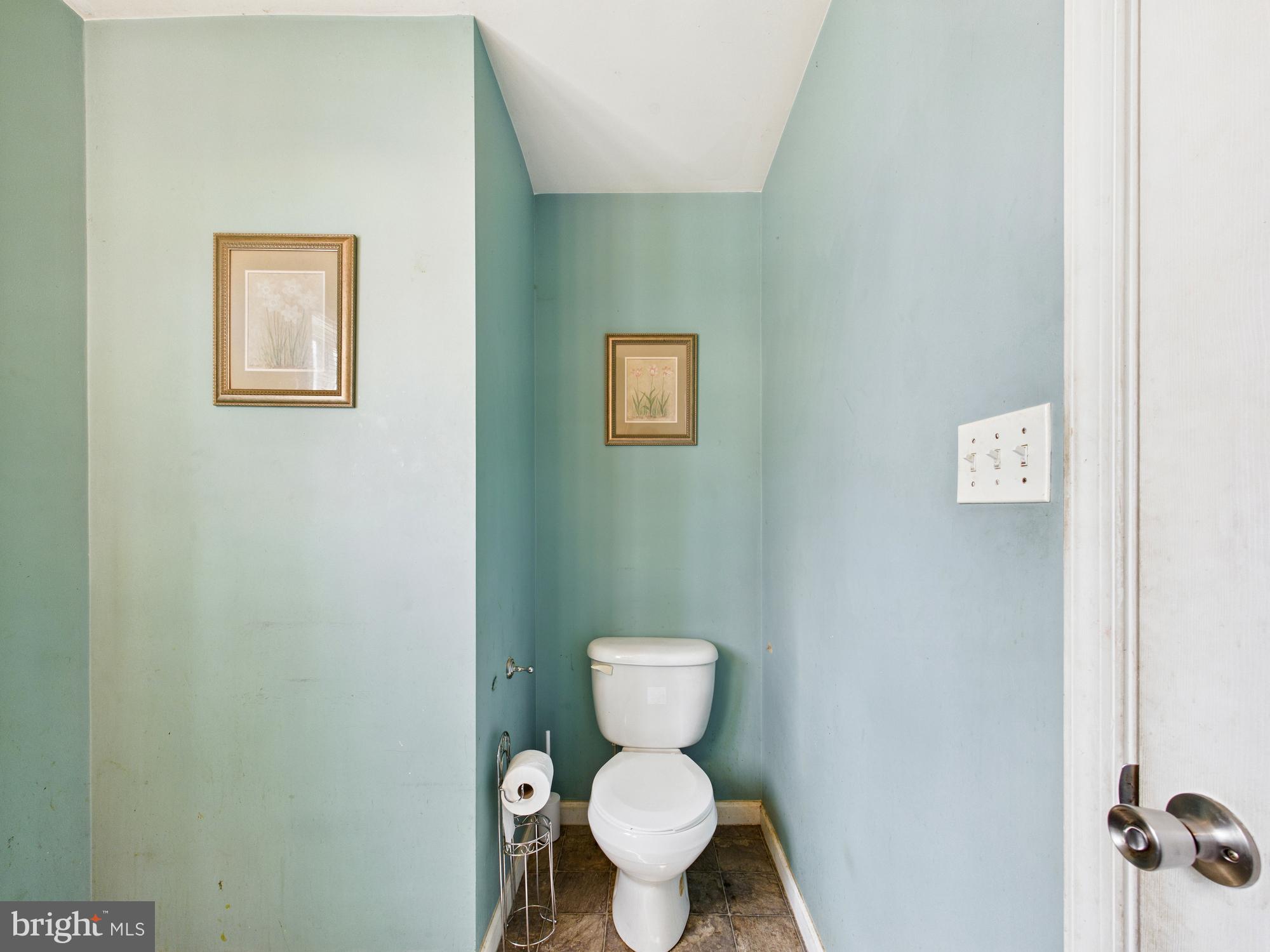 1176 West 6th Street Laurel, DE 19956 - Photo 30 of 42 a white toilet sitting in a bathroom next to a sink