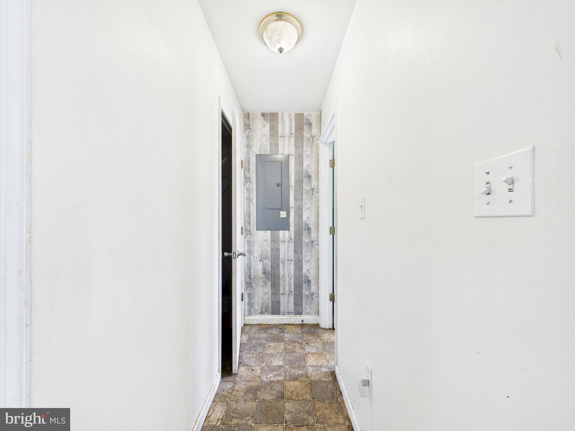 1176 West 6th Street Laurel, DE 19956 - Photo 32 of 42 a view of a hallway with paintings on the wall