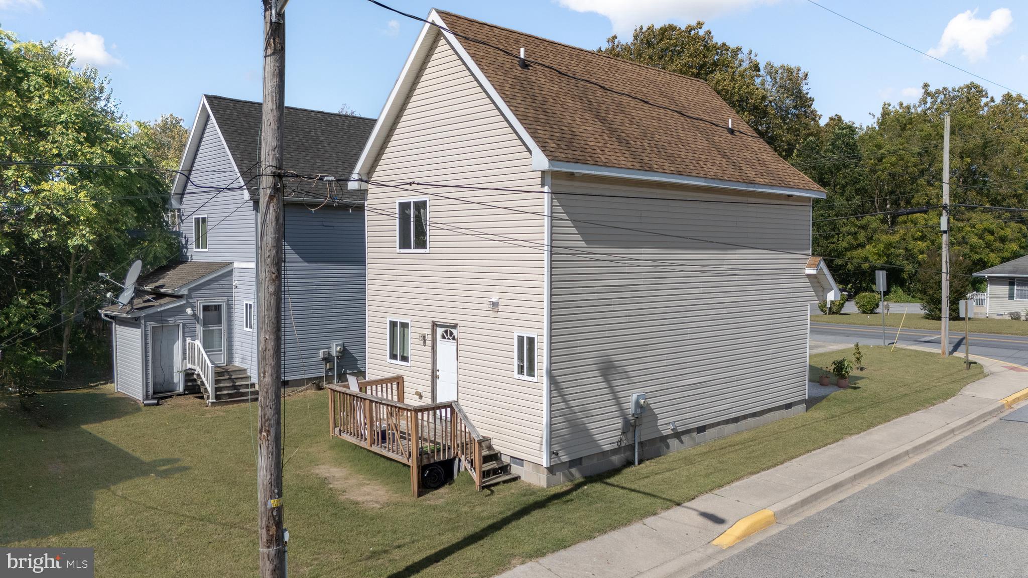 1176 West 6th Street Laurel, DE 19956 - Photo 7 of 42 a view of a white house with a yard