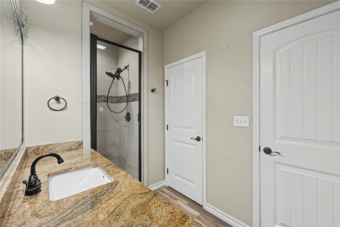 302 Cooper Road, Unit E2 Odem, TX 78370 - Photo 12 of 24 a bathroom with a granite countertop sink and a mirror
