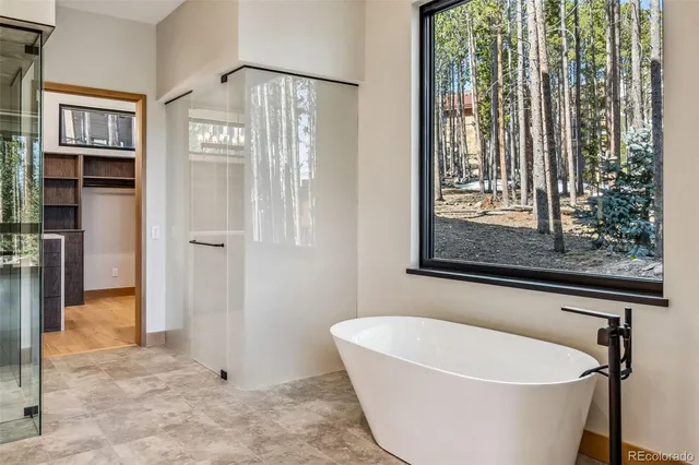 a white bath tub sitting next to a window