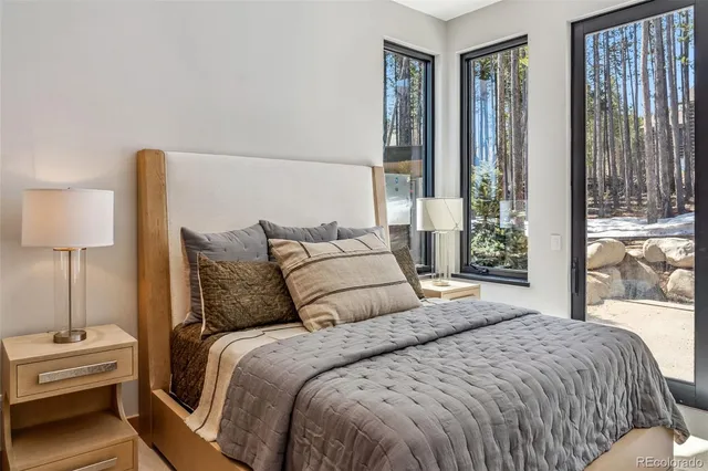 a bedroom with a bed and large window