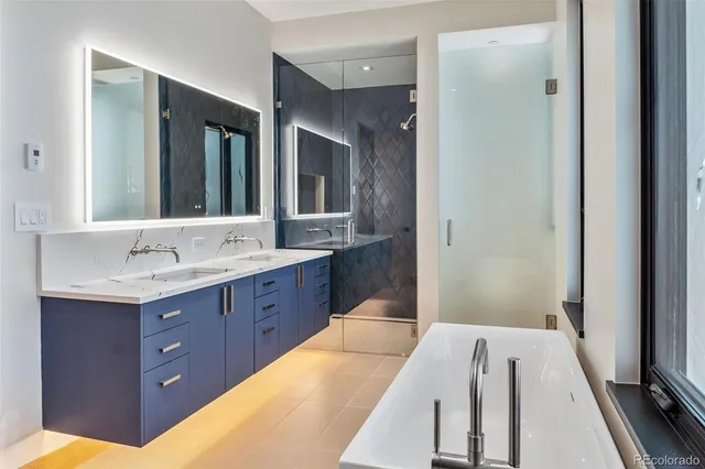 a spacious bathroom with a double vanity sink and mirror