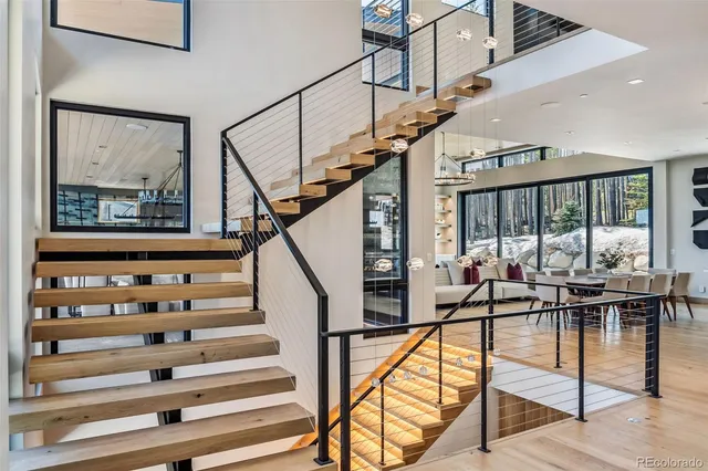a view of staircase with furniture and wooden floor