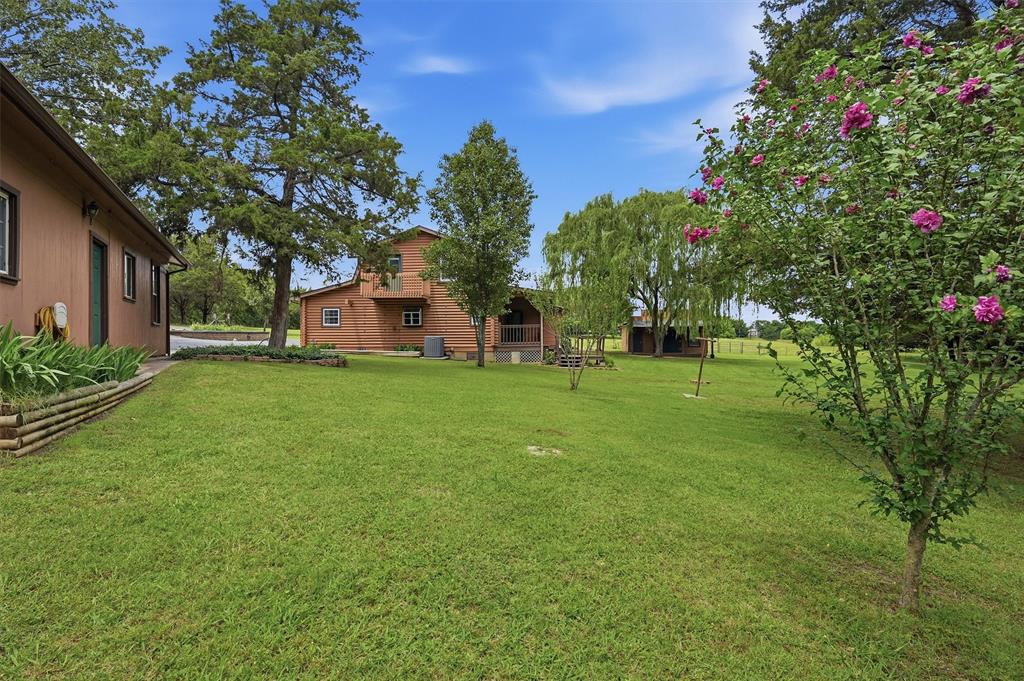 570 Ayres Road Bells, TX 75414 - Photo 7 of 40 a view of a house with a big yard and large tree