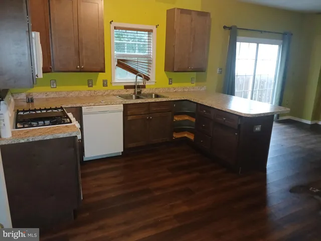 a kitchen with wooden cabinets and a sink
