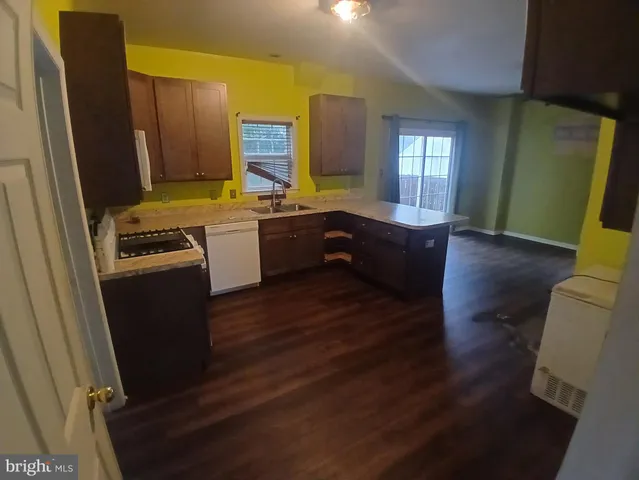 a kitchen with a sink stove and refrigerator