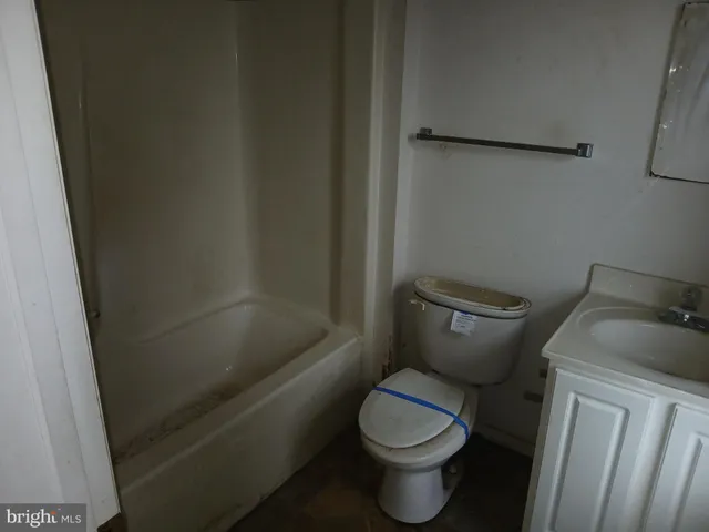a white toilet sitting next to a shower