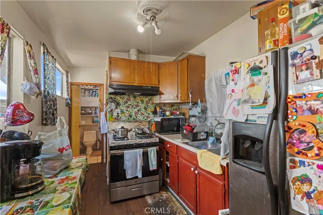 a kitchen with stainless steel appliances granite countertop a stove a refrigerator and a microwave