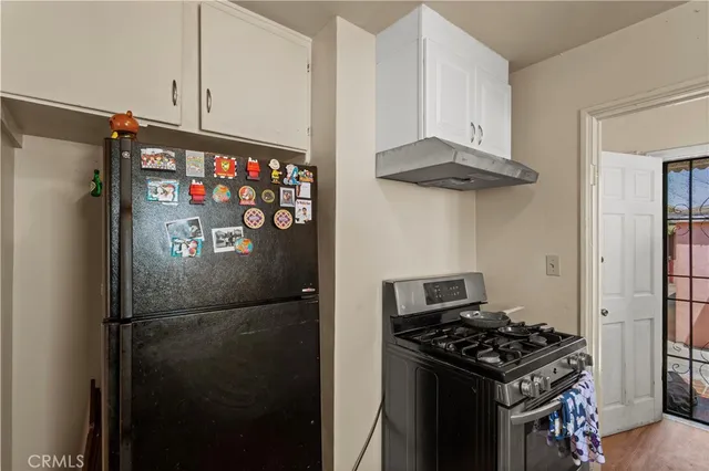 a kitchen with stainless steel appliances granite countertop a refrigerator and a stove