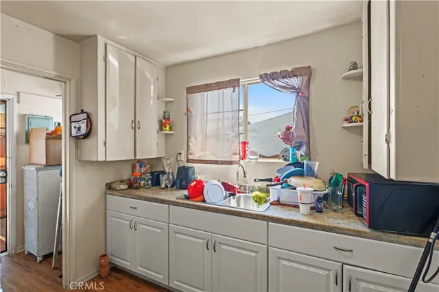a kitchen with sink refrigerator and cabinets