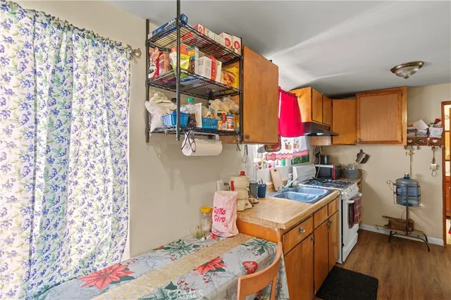 a kitchen with stainless steel appliances a stove a sink and a refrigerator