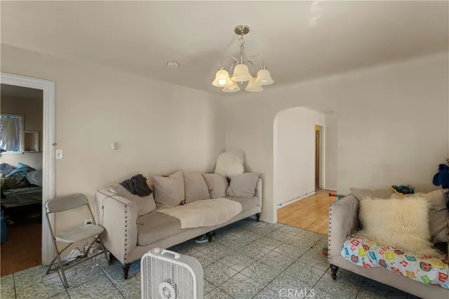 a living room with furniture a chandelier and a couch