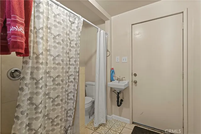 a bathroom with a sink toilet and mirror