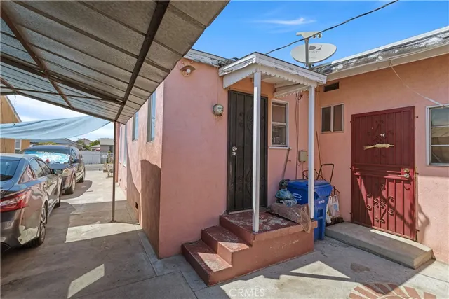 a view of a patio with table and chairs and potted plants