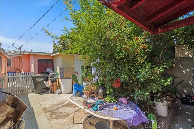 a view of a patio with table and chairs