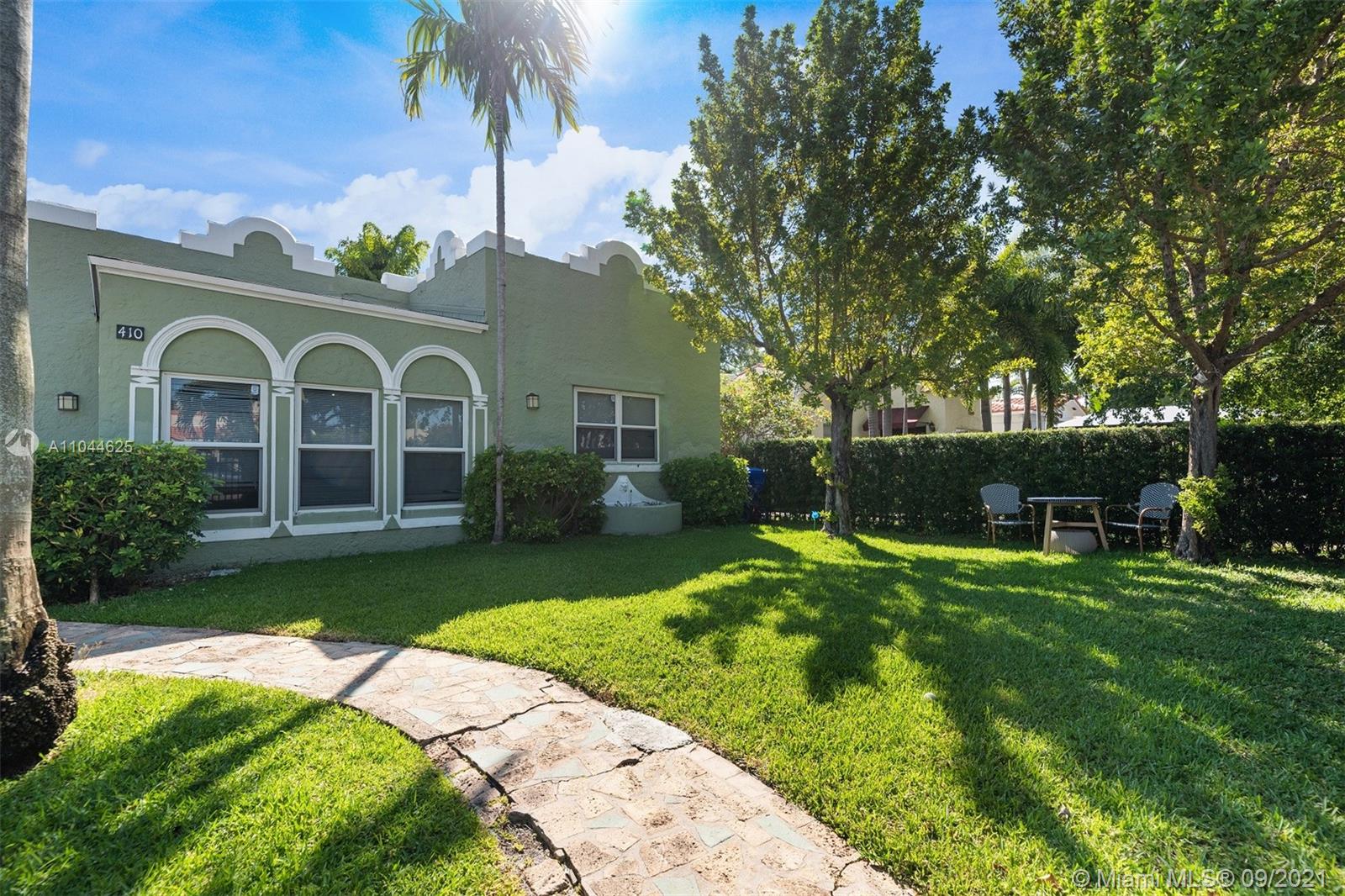 410 Southwest 22nd Road Miami, FL 33129 - Photo 2 of 37 a front view of a house with a garden and trees