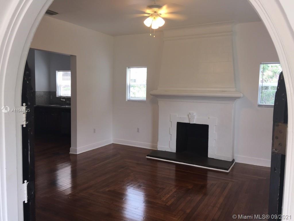 410 Southwest 22nd Road Miami, FL 33129 - Photo 11 of 37 a view of a livingroom with wooden floor and a fireplace