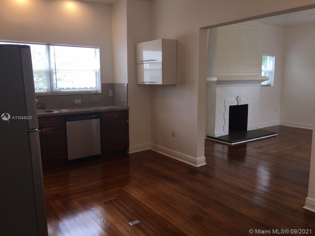 410 Southwest 22nd Road Miami, FL 33129 - Photo 12 of 37 an empty room with wooden floor a fireplace and windows