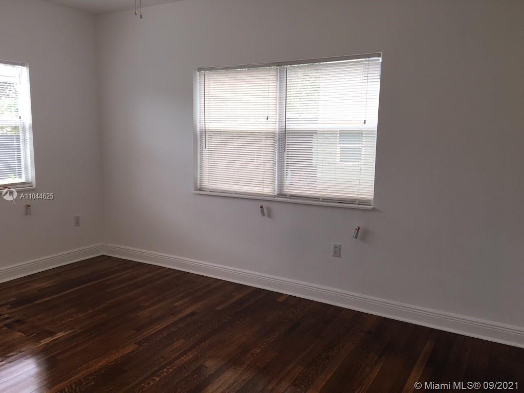 410 Southwest 22nd Road Miami, FL 33129 - Photo 15 of 37 an empty room with wooden floor and windows