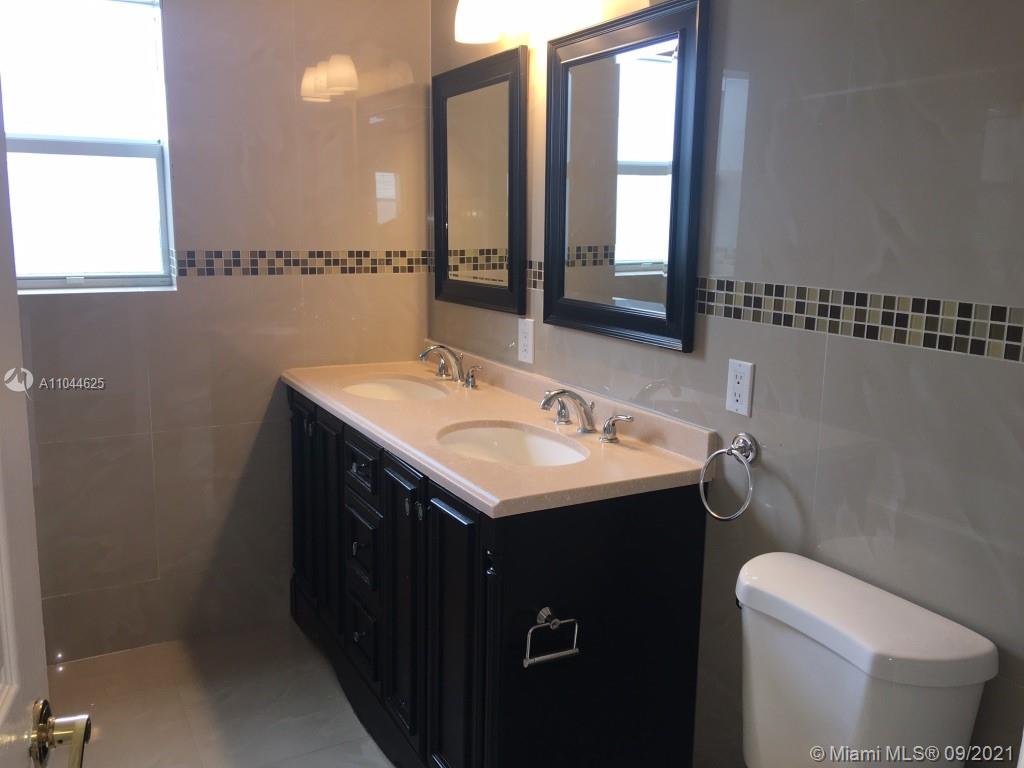 410 Southwest 22nd Road Miami, FL 33129 - Photo 16 of 37 a bathroom with a sink and a toilet