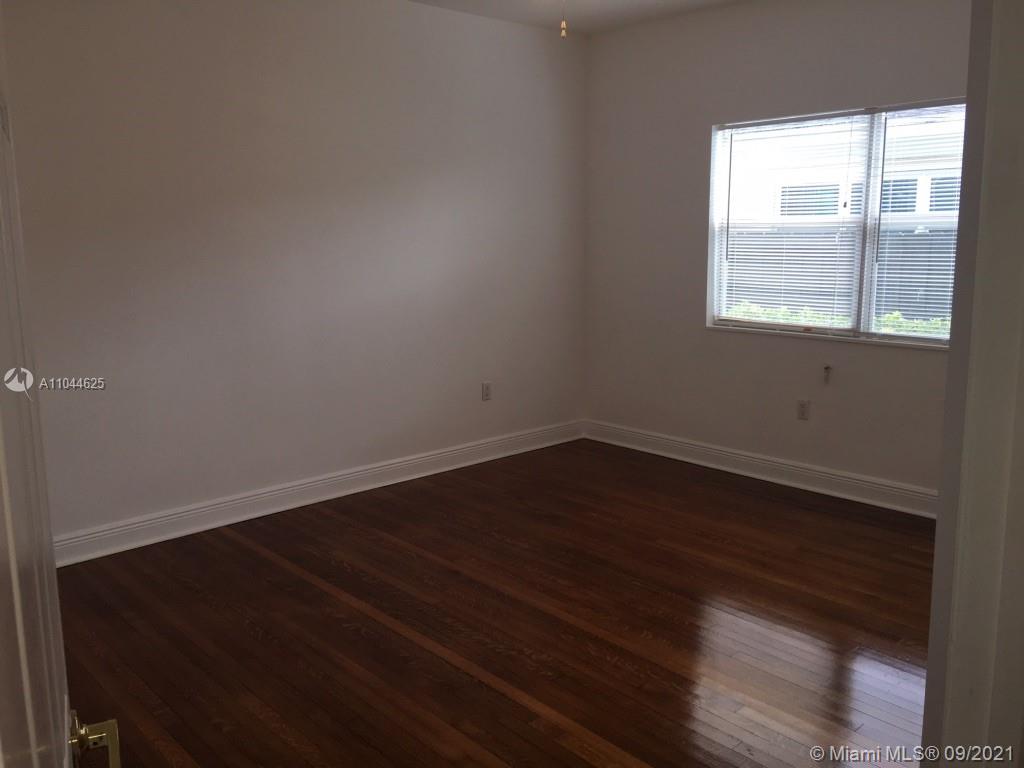 410 Southwest 22nd Road Miami, FL 33129 - Photo 17 of 37 a view of an empty room with wooden floor and a window