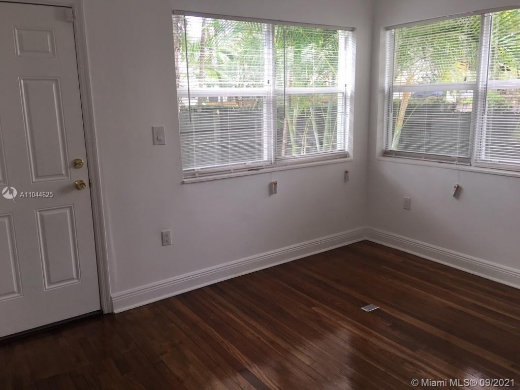 410 Southwest 22nd Road Miami, FL 33129 - Photo 19 of 37 a view of an empty room with wooden floor and a window