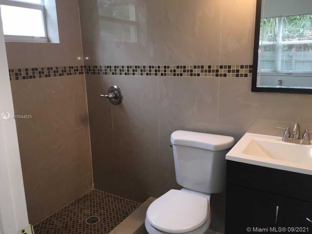 410 Southwest 22nd Road Miami, FL 33129 - Photo 20 of 37 a white toilet sitting next to a bathroom sink