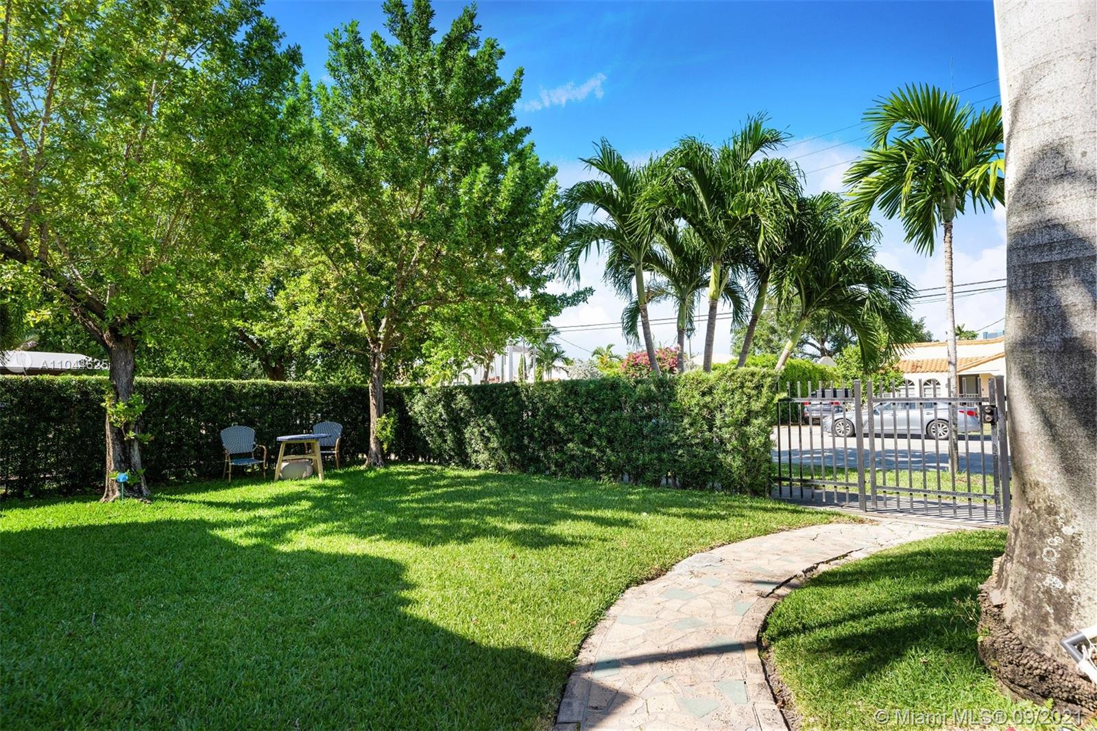 410 Southwest 22nd Road Miami, FL 33129 - Photo 3 of 37 a view of a park with a big yard and palm trees