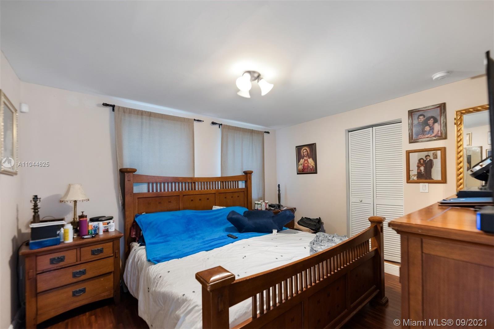 410 Southwest 22nd Road Miami, FL 33129 - Photo 26 of 37 a bedroom with furniture a flat screen tv and a window