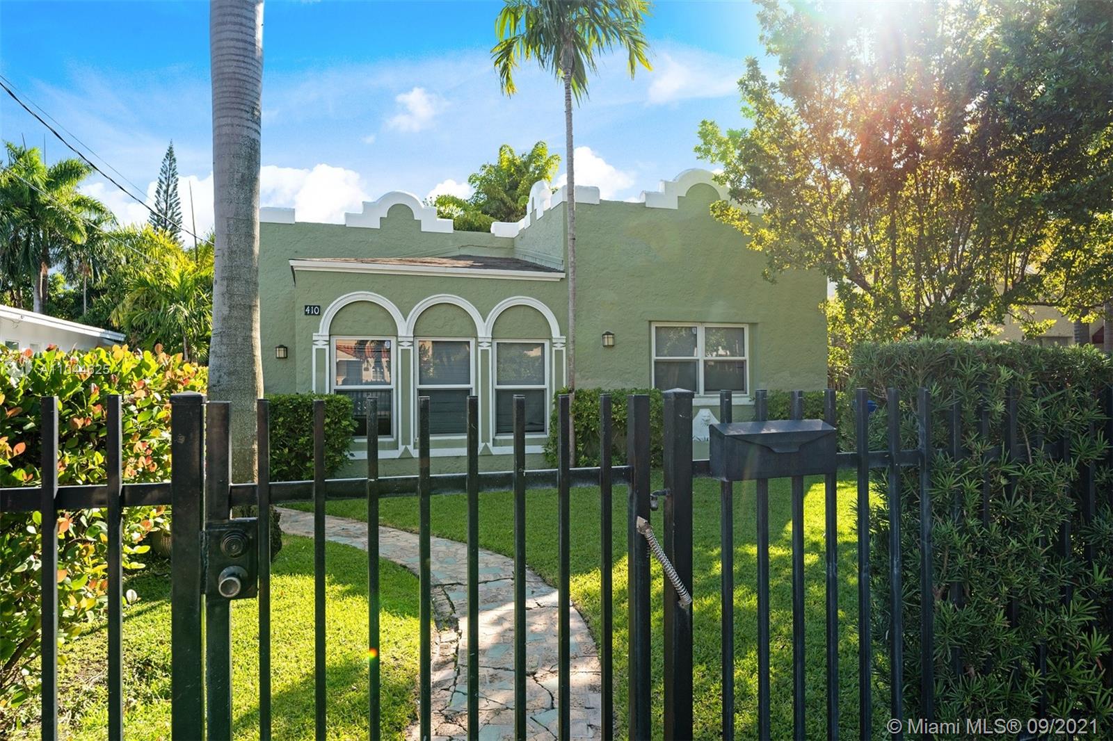 410 Southwest 22nd Road Miami, FL 33129 - Photo 4 of 37 a front view of a house with a garden