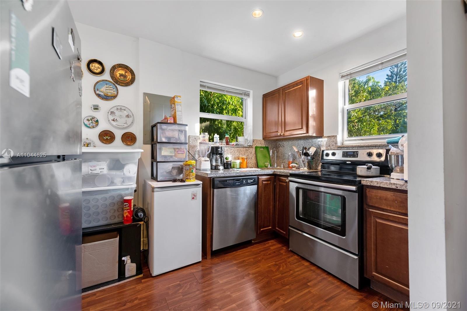 410 Southwest 22nd Road Miami, FL 33129 - Photo 31 of 37 a kitchen with a stove a sink and a microwave