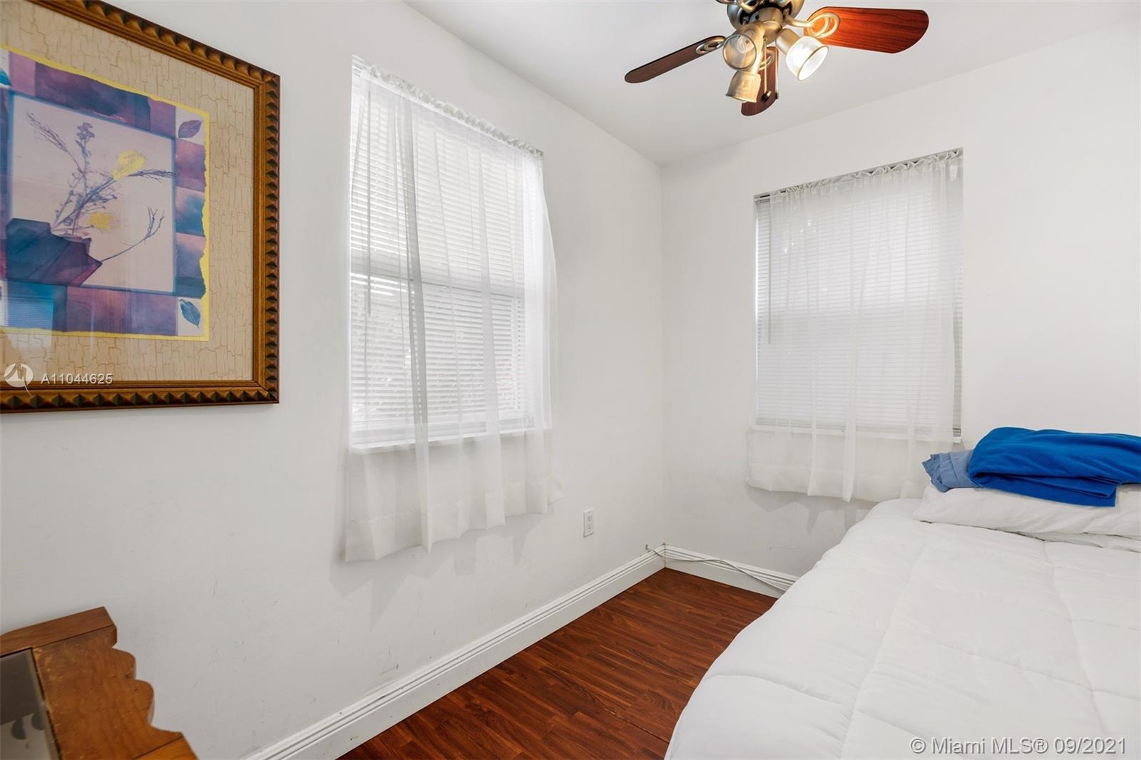 410 Southwest 22nd Road Miami, FL 33129 - Photo 33 of 37 a bedroom with a bed and a painting on the wall