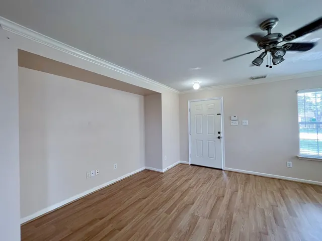 a view of room with hardwood floor and ceiling fan