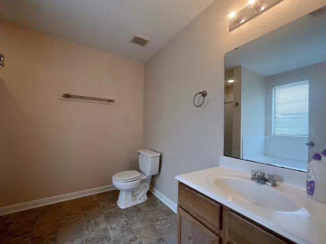 a bathroom with a sink toilet and a mirror