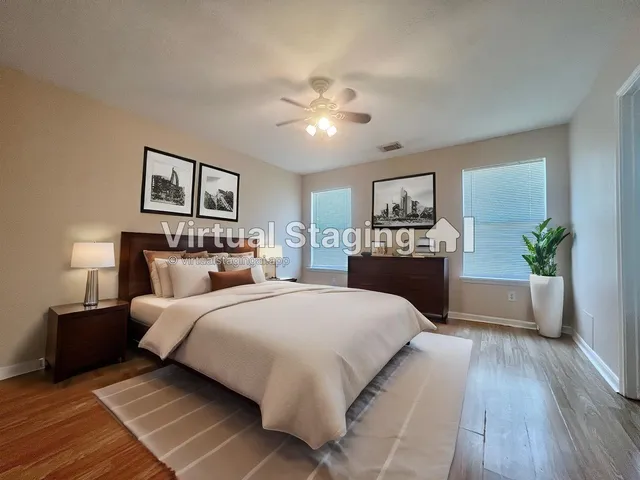 a bedroom with a large bed and a chandelier